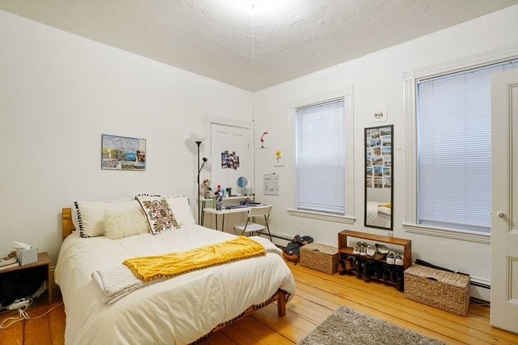 68 Calumet Street, Unit 3 Boston, MA 02120 - Photo 6 of 9 a bedroom with a bed and wooden floor