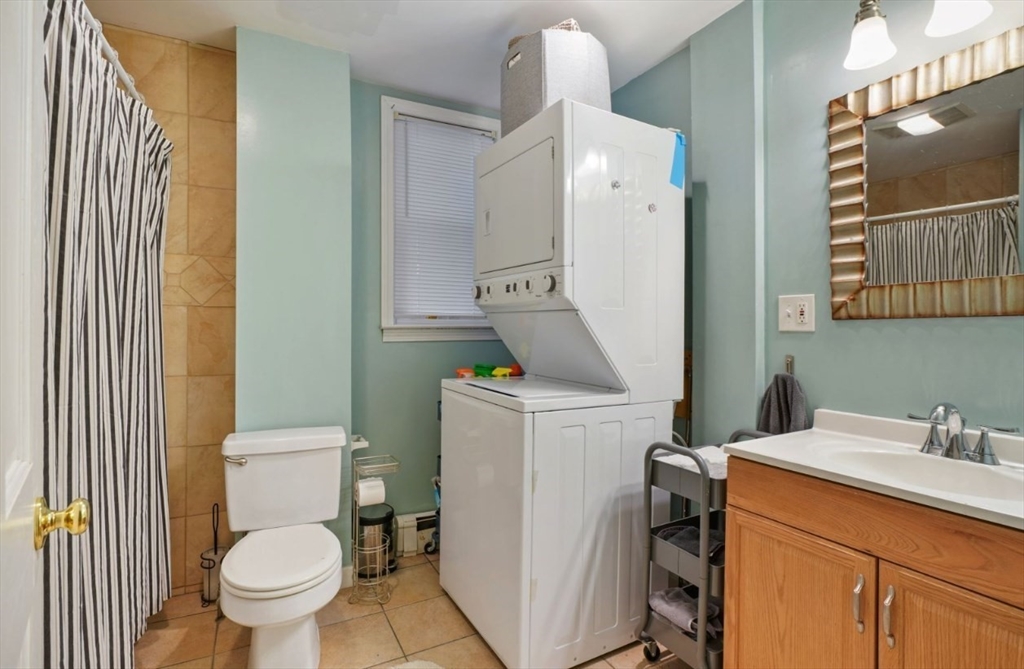 68 Calumet Street, Unit 3 Boston, MA 02120 - Photo 8 of 9 a bathroom with a sink a toilet and a mirror