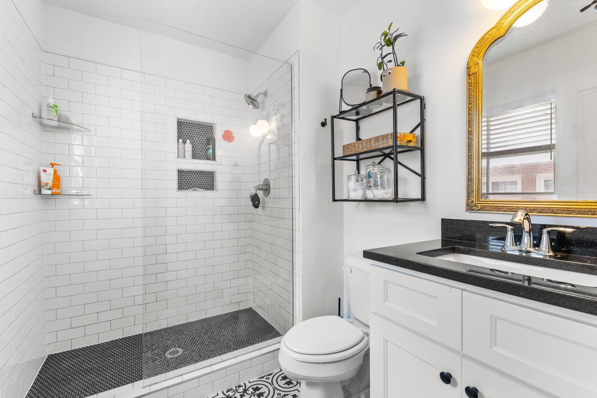 809 Coleman Street Raleigh, NC 27610 - Photo 15 of 70 a bathroom with a granite countertop sink mirror vanity and toilet