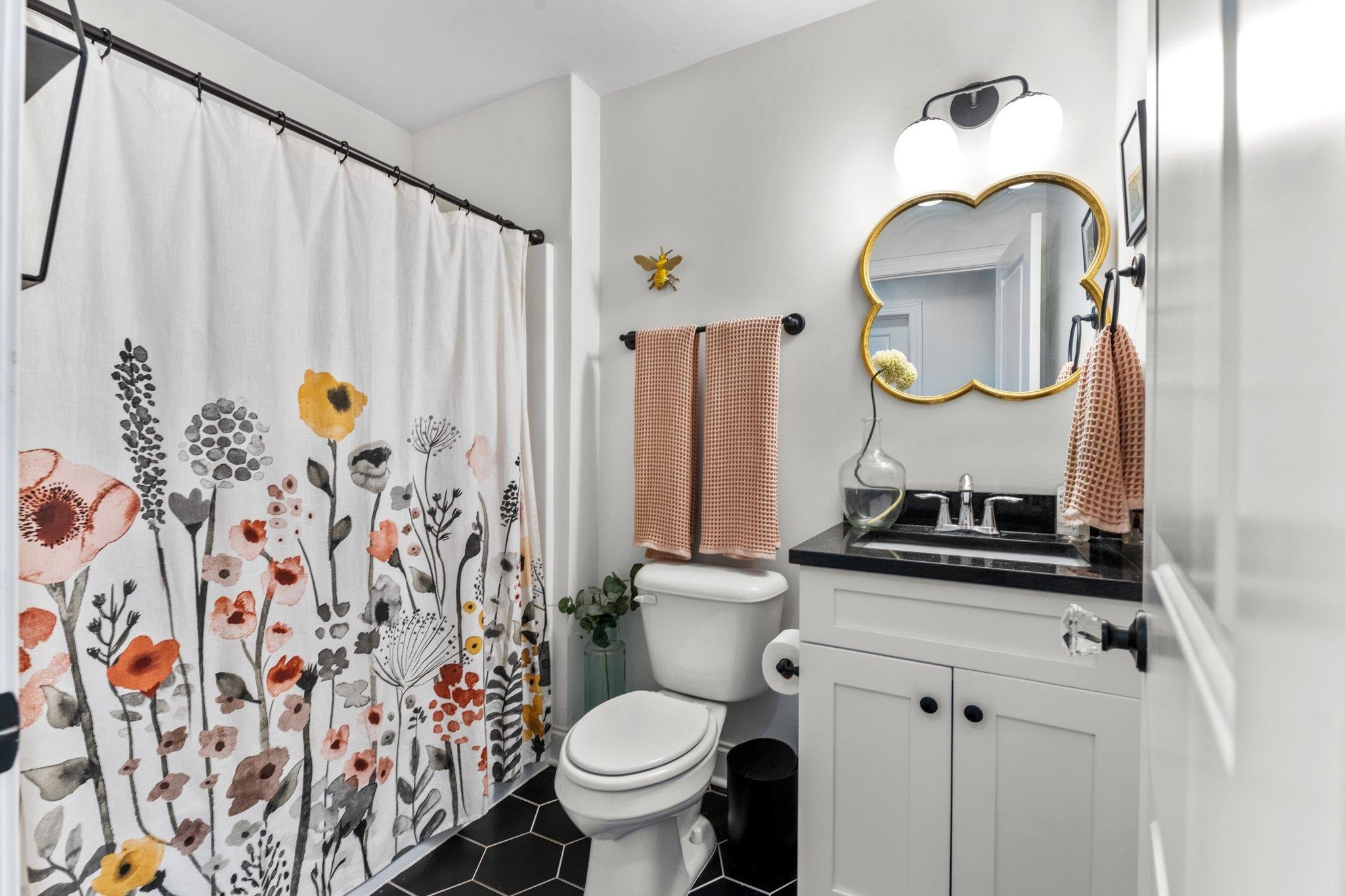 809 Coleman Street Raleigh, NC 27610 - Photo 19 of 70 a bathroom with a sink toilet and mirror