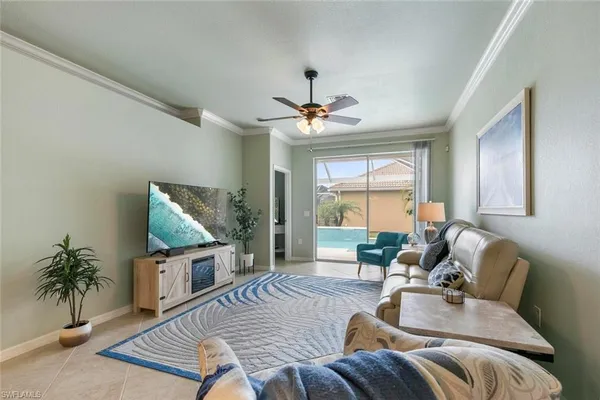 a living room with furniture a large window and a flat screen tv