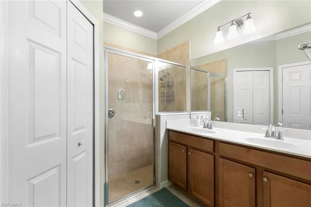 a bathroom with a double vanity sink mirror and shower