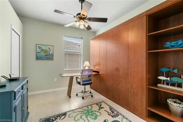 a room with painting on the wall and a window