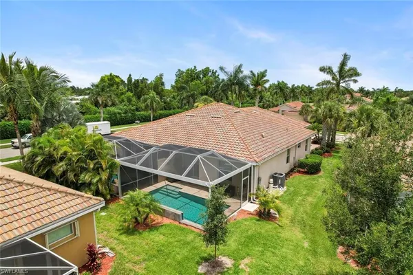 a aerial view of a house with a yard and potted plants