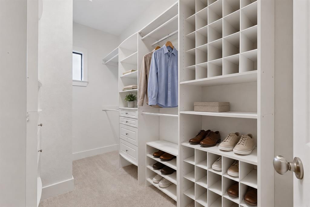4211 Rawlins Street, Unit 528 Dallas, TX 75219 - Photo 10 of 14 Custom-built closet system featuring ample shelving, integrated drawers, hanging rods, and dedicated shoe cubbies