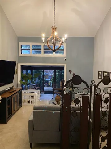 a living room with furniture ceiling fan and a wooden floor