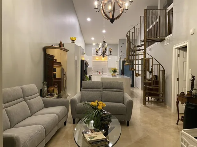 a kitchen with stainless steel appliances a refrigerator sink and wooden floor