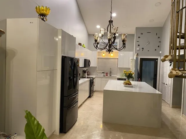 a kitchen with stainless steel appliances a refrigerator and a stove