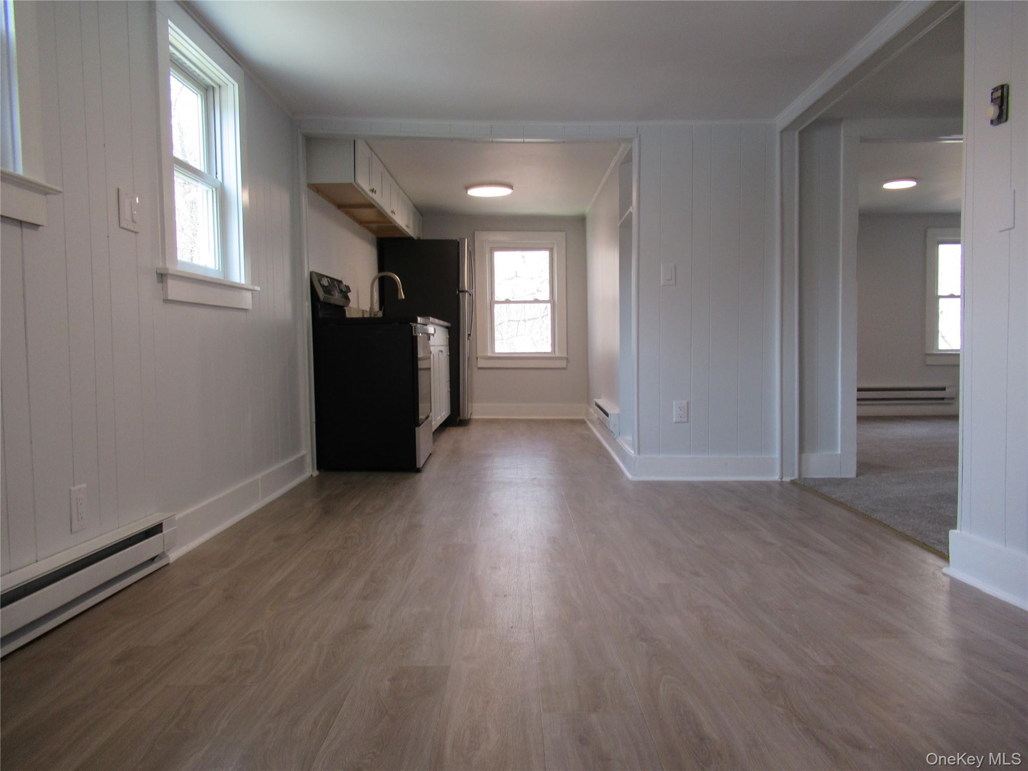 300 Old Rte 55, Unit 5 Poughquag, NY 12570 - Photo 5 of 20 an empty room with wooden floor and windows