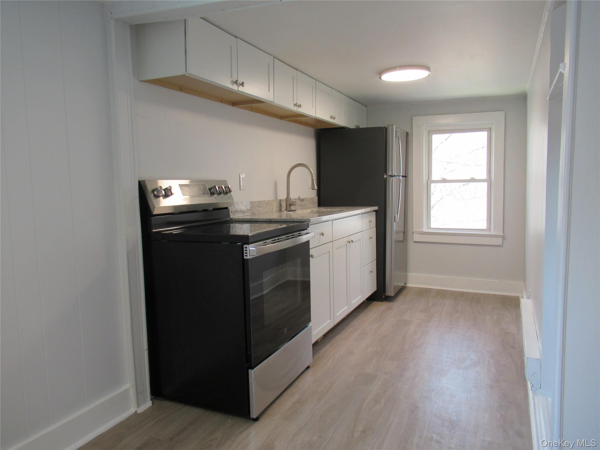 300 Old Rte 55, Unit 5 Poughquag, NY 12570 - Photo 6 of 20 a kitchen with stainless steel appliances granite countertop a stove a sink and a refrigerator