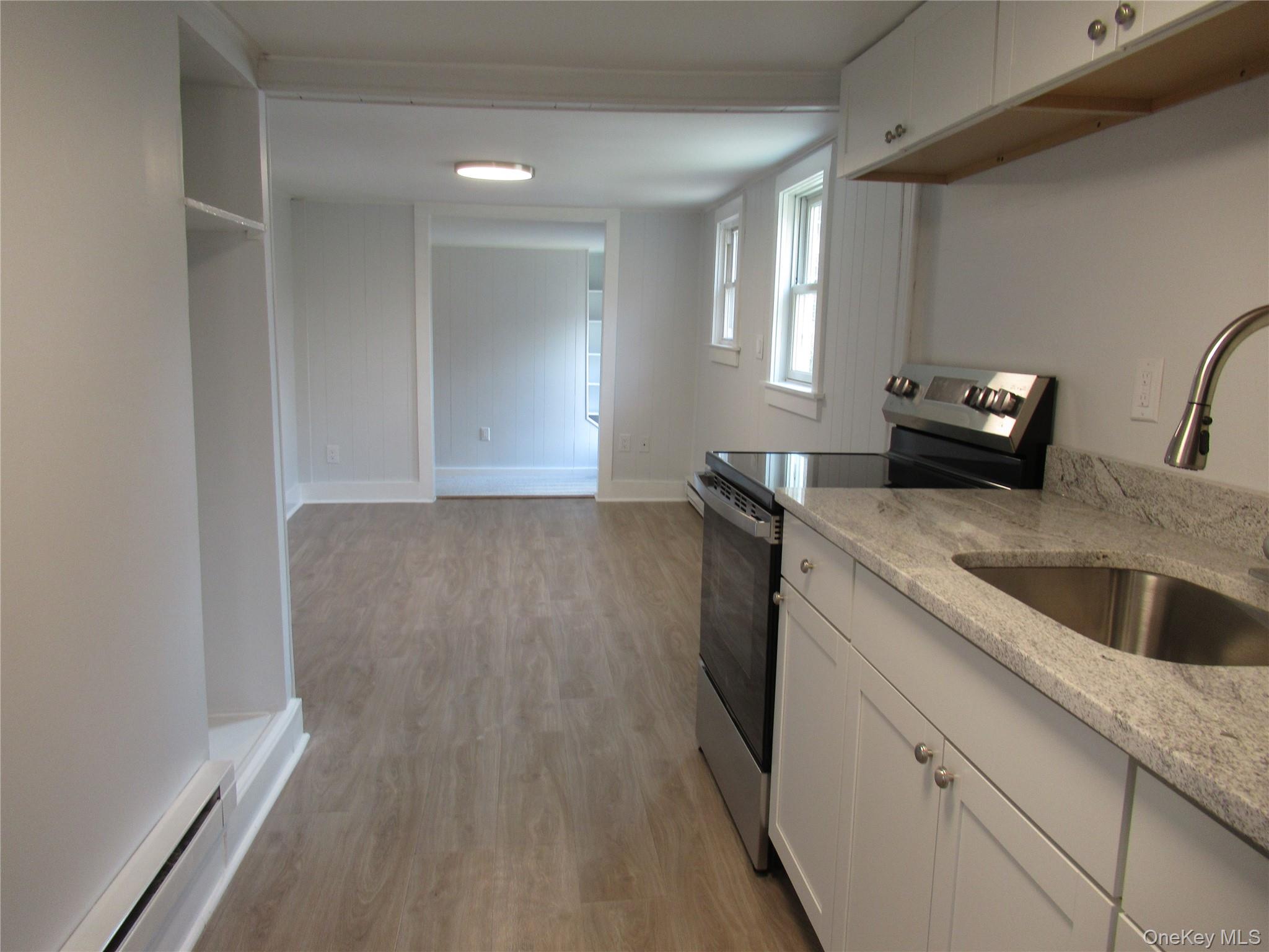 300 Old Rte 55, Unit 5 Poughquag, NY 12570 - Photo 7 of 20 a kitchen with granite countertop a sink and a stove top oven