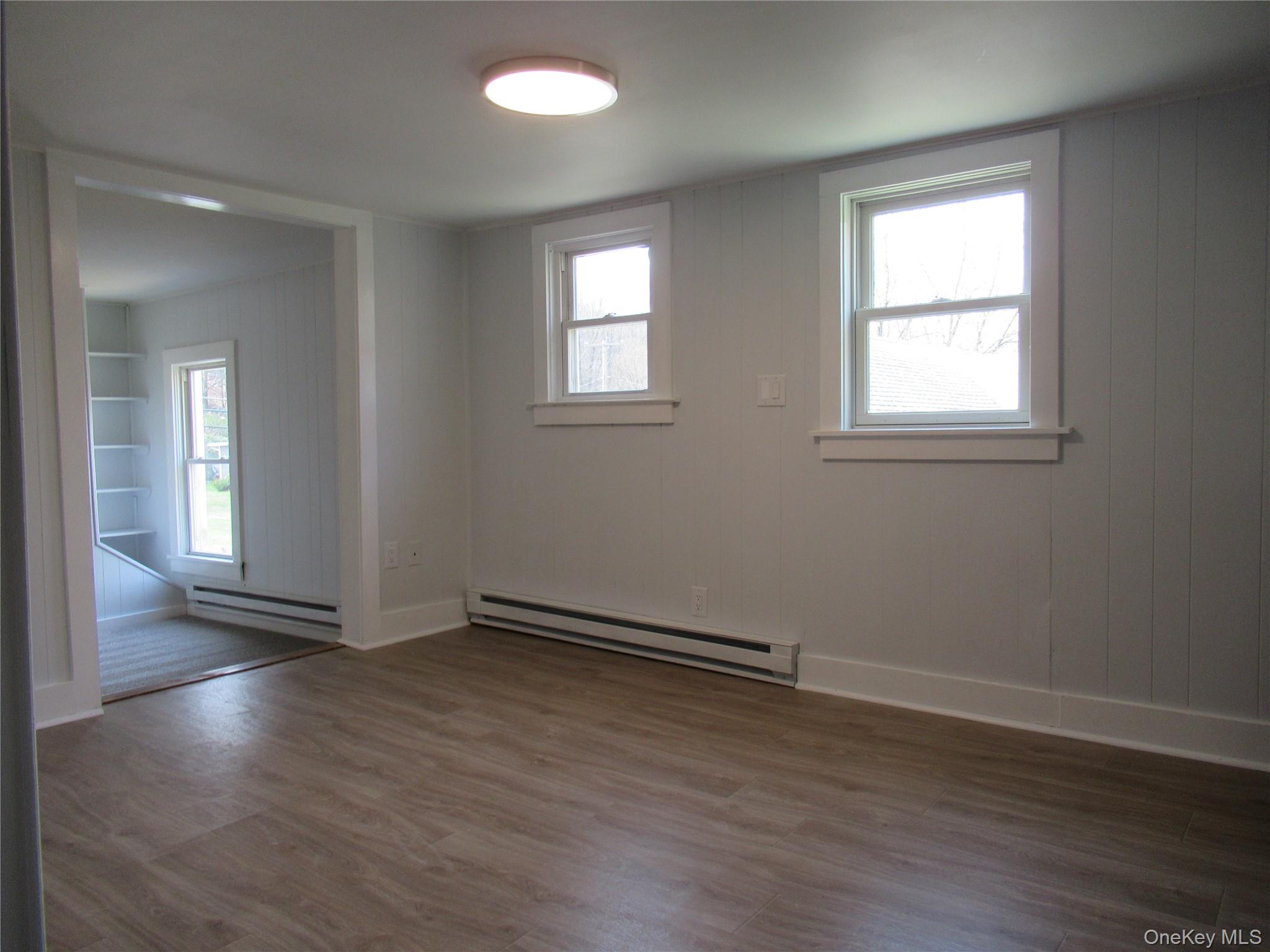 300 Old Rte 55, Unit 5 Poughquag, NY 12570 - Photo 10 of 20 an empty room with wooden floor and windows