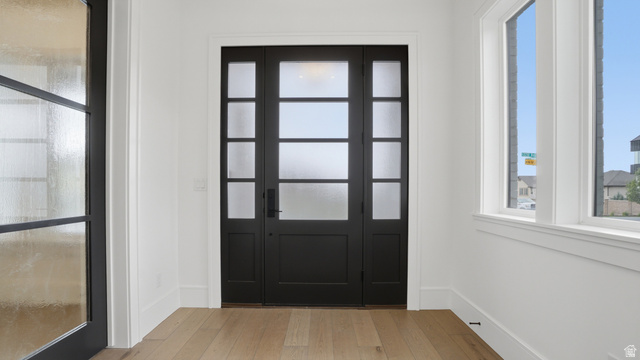 1682 North 1950 W Street, Unit 9 Provo, UT 84604 - Photo 10 of 84 Entryway featuring a black multi-paneled door with frosted glass, flanked by matching sidelights and transom