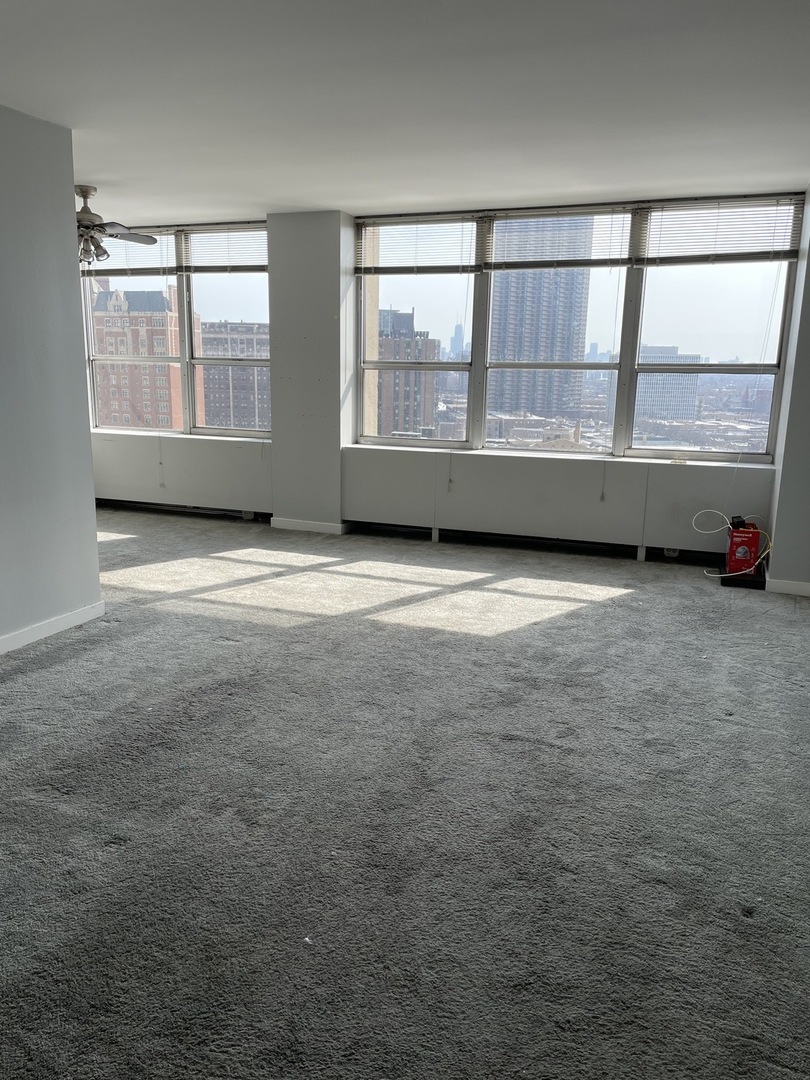 Undisclosed Address Chicago, IL 60613 - Photo 4 of 15 an empty room with wooden floor and windows