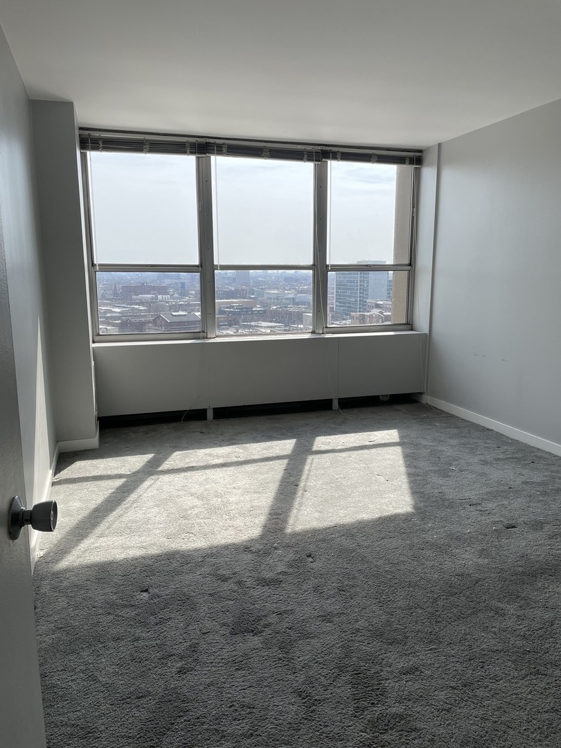 Undisclosed Address Chicago, IL 60613 - Photo 7 of 15 an empty room with a large window