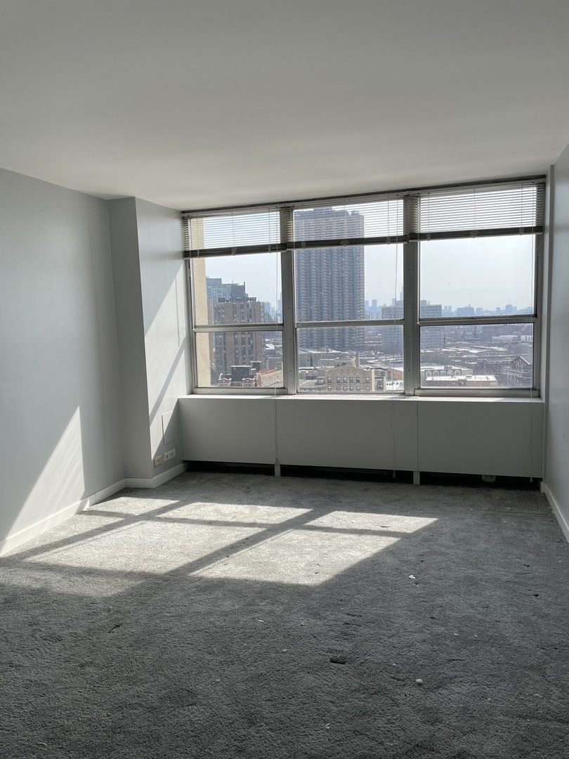 Undisclosed Address Chicago, IL 60613 - Photo 8 of 15 a view of an empty room with a window