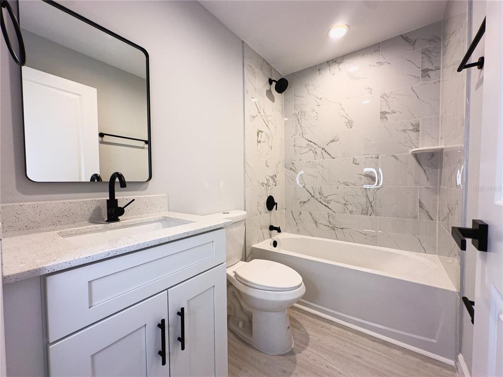 3602 Gillot Boulevard Port Charlotte, FL 33981 - Photo 12 of 28 a bathroom with a sink a toilet and a bathtub