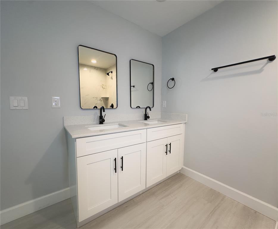3602 Gillot Boulevard Port Charlotte, FL 33981 - Photo 15 of 28 a bathroom with 2 sink and a mirror