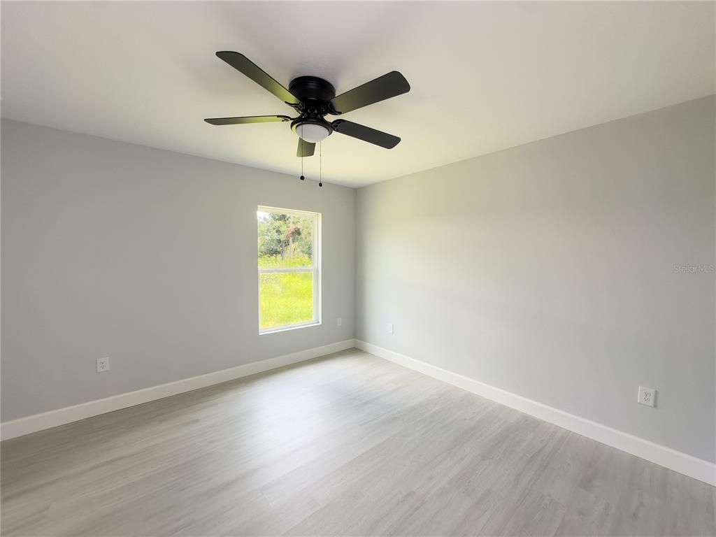 3602 Gillot Boulevard Port Charlotte, FL 33981 - Photo 17 of 28 an empty room with a window and a ceiling fan