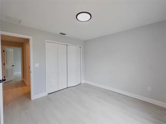 a view of a room with rack and wooden cabinets