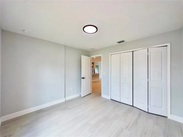 a view of an empty room and wooden floor