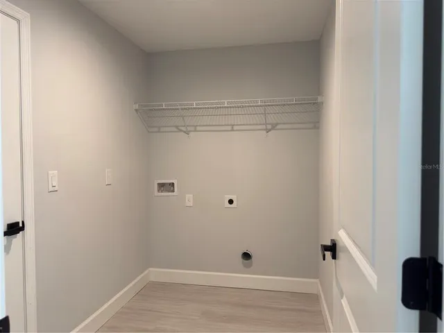 a view of a room with wooden floor