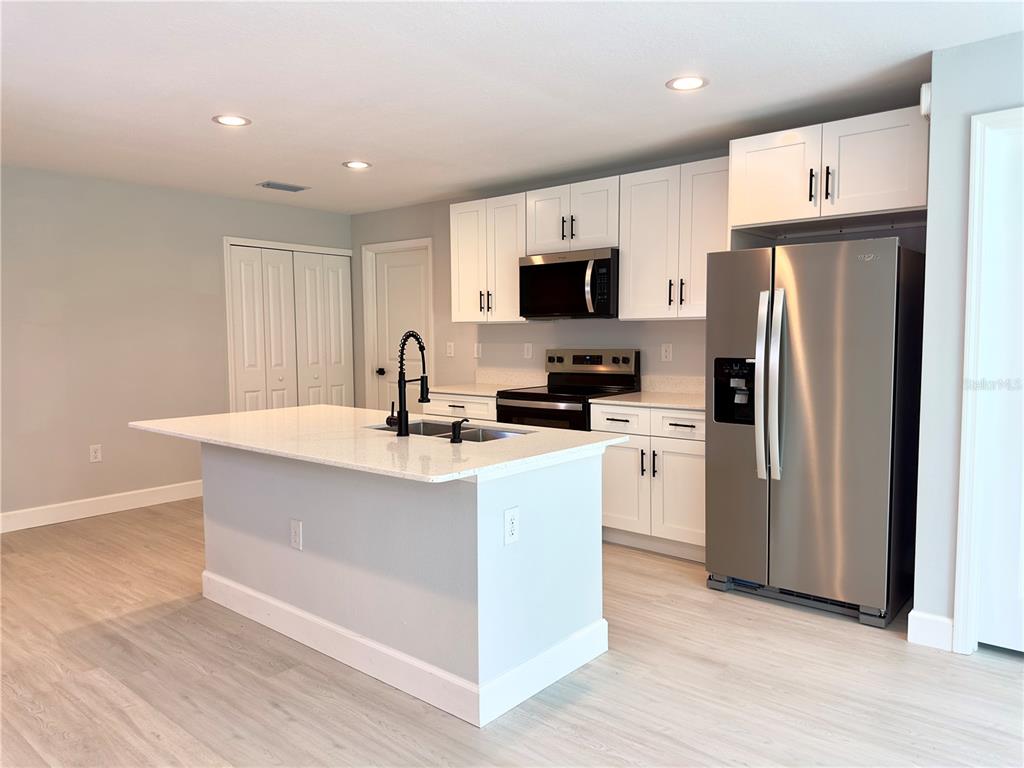 3602 Gillot Boulevard Port Charlotte, FL 33981 - Photo 9 of 28 a kitchen with stainless steel appliances a refrigerator stove and microwave