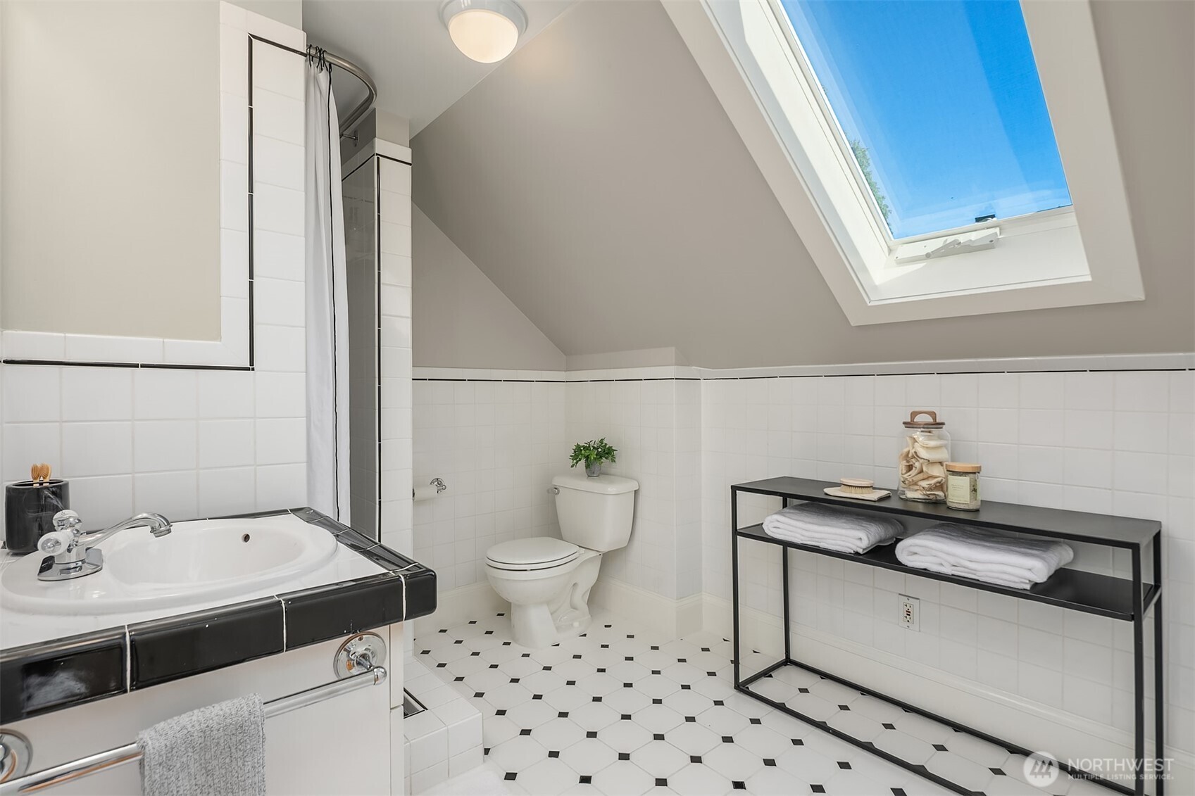 902 North 93rd Street Seattle, WA 98103 - Photo 15 of 34 a bathroom with a sink toilet and vanity