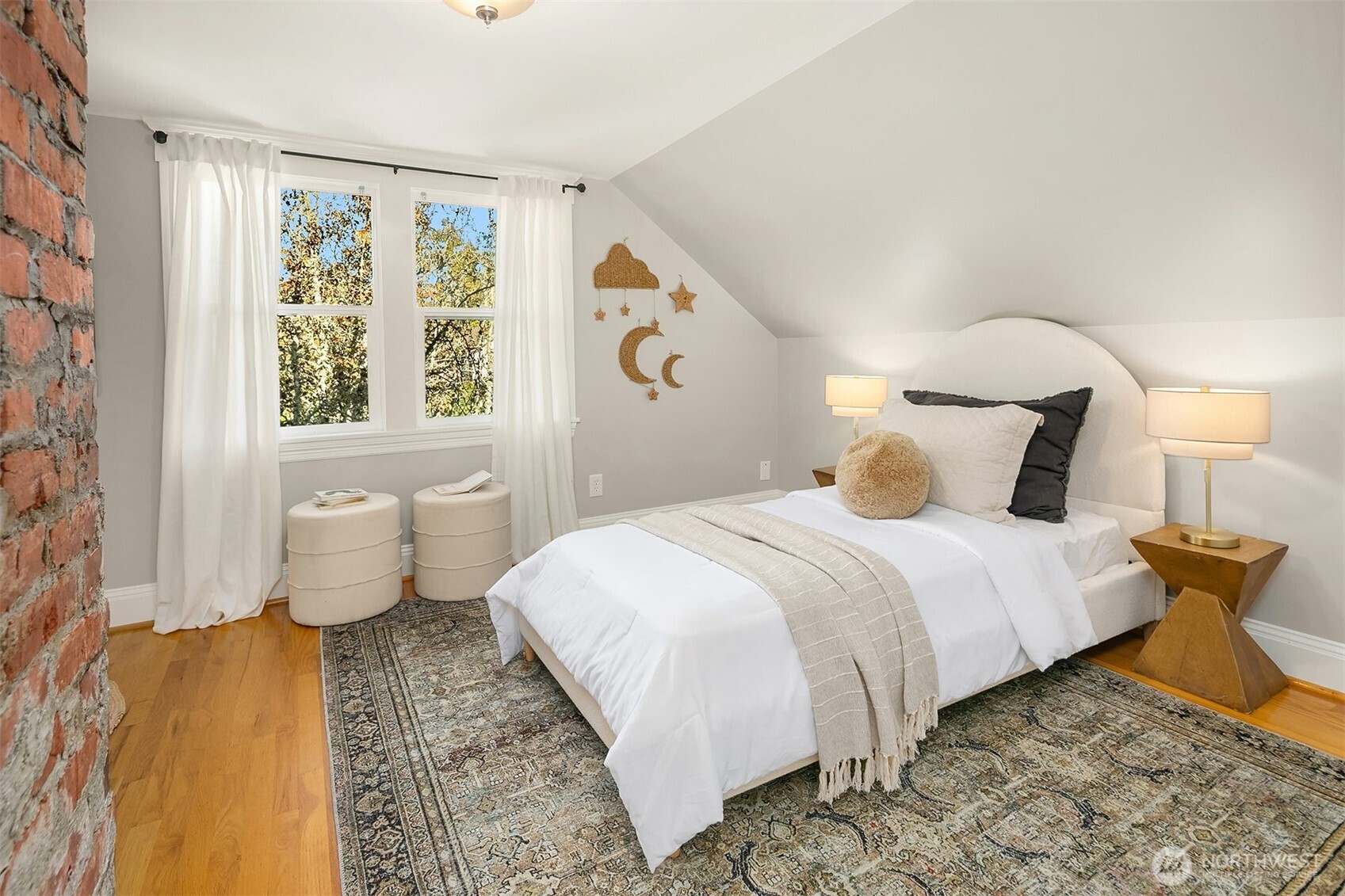 902 North 93rd Street Seattle, WA 98103 - Photo 17 of 34 a bedroom with a bed and wooden floor