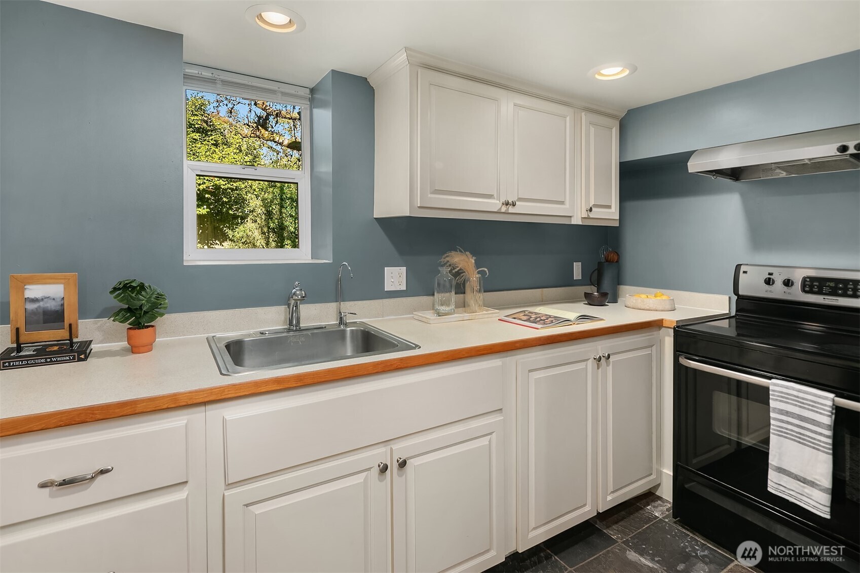 902 North 93rd Street Seattle, WA 98103 - Photo 22 of 34 a kitchen with a sink cabinets and window