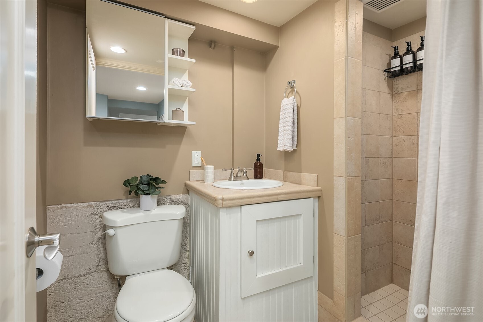 902 North 93rd Street Seattle, WA 98103 - Photo 25 of 34 a bathroom with a toilet sink and mirror