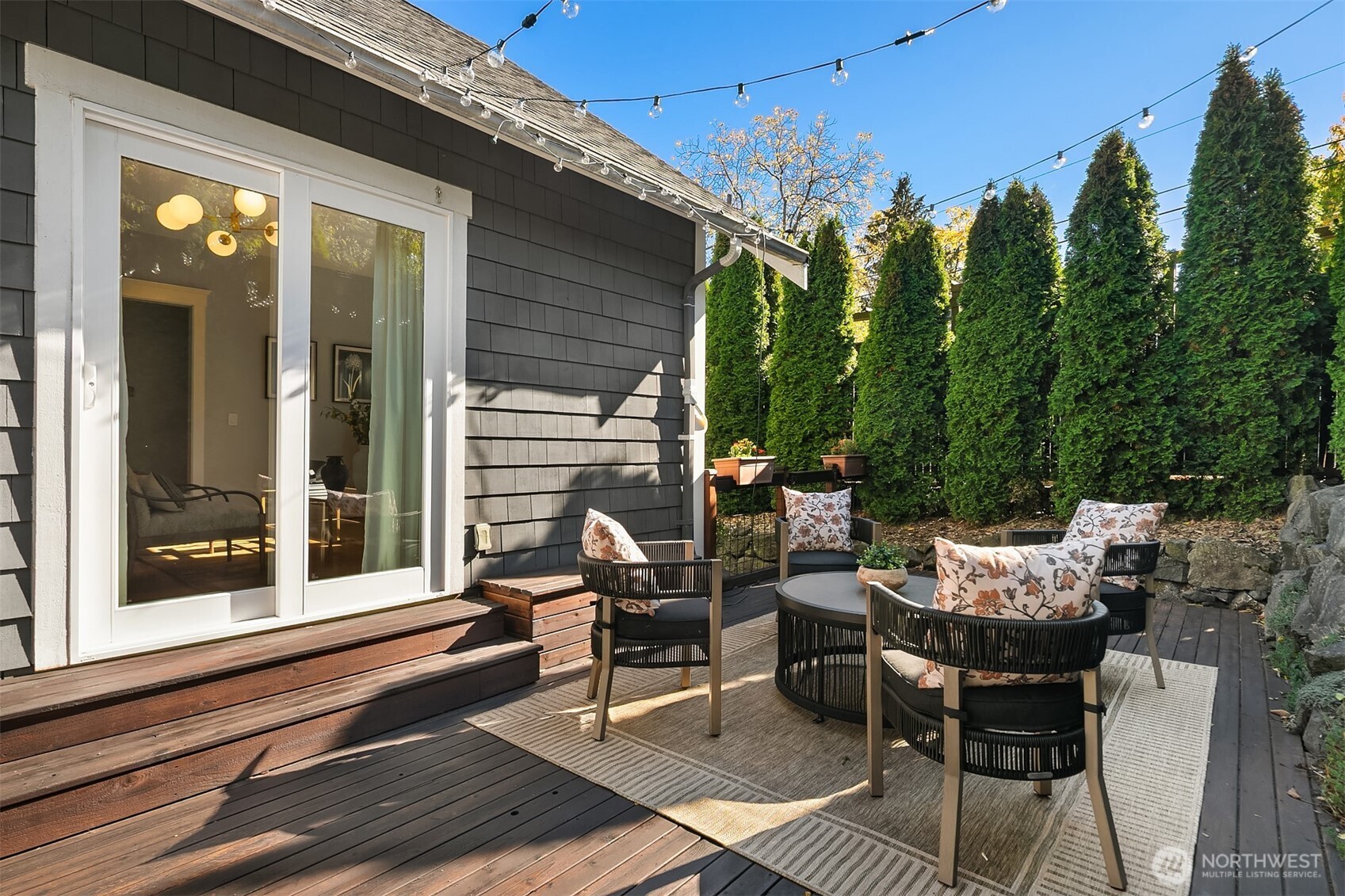 902 North 93rd Street Seattle, WA 98103 - Photo 27 of 34 a view of a patio with a table and chairs and floor to ceiling window and potted plants