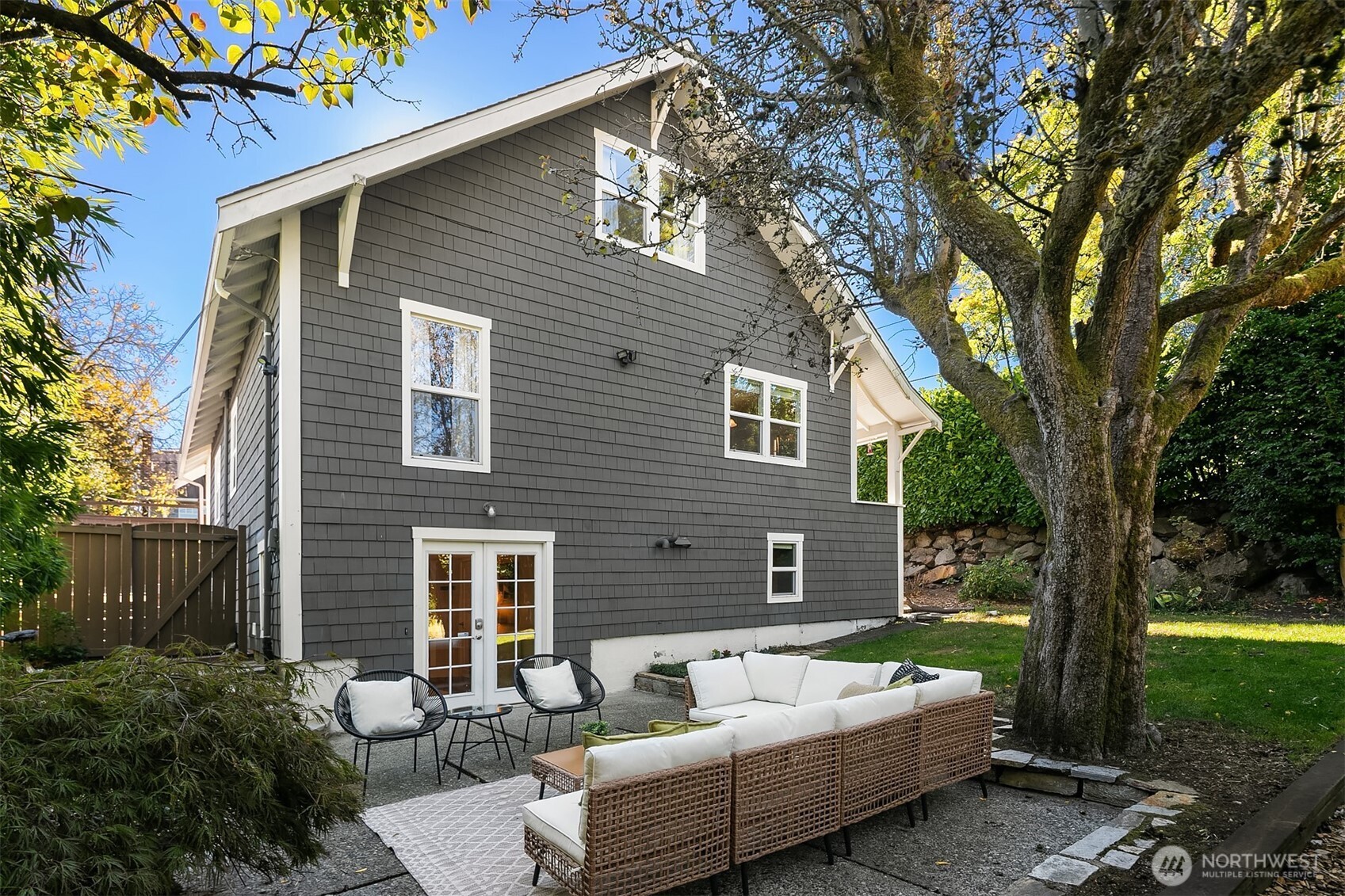 902 North 93rd Street Seattle, WA 98103 - Photo 30 of 34 a view of a patio with couches table and chairs and potted plants