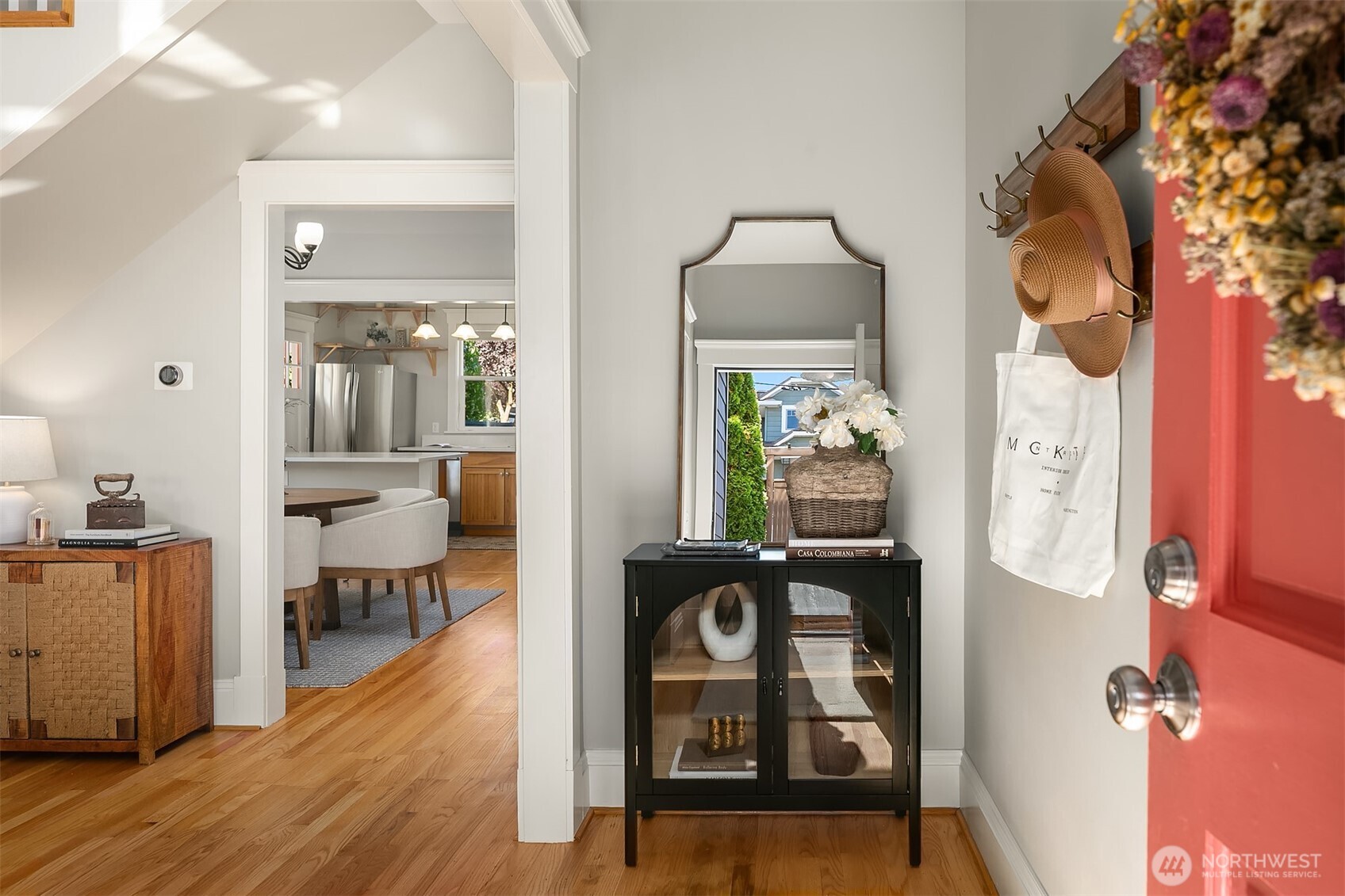902 North 93rd Street Seattle, WA 98103 - Photo 3 of 34 a view of a hallway to a livingroom and a dinning room with wooden floor