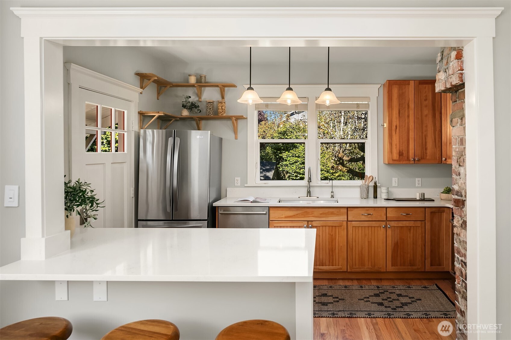 902 North 93rd Street Seattle, WA 98103 - Photo 8 of 34 a kitchen with stainless steel appliances granite countertop a sink and a refrigerator
