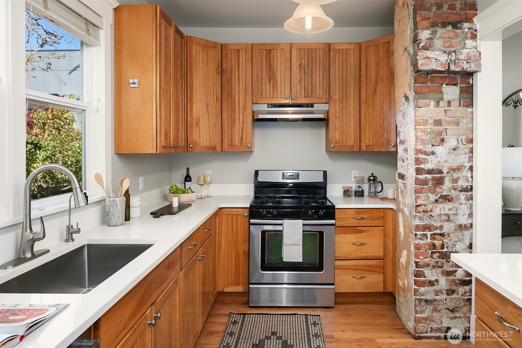 902 North 93rd Street Seattle, WA 98103 - Photo 9 of 34 a kitchen with stainless steel appliances a stove a sink and a microwave