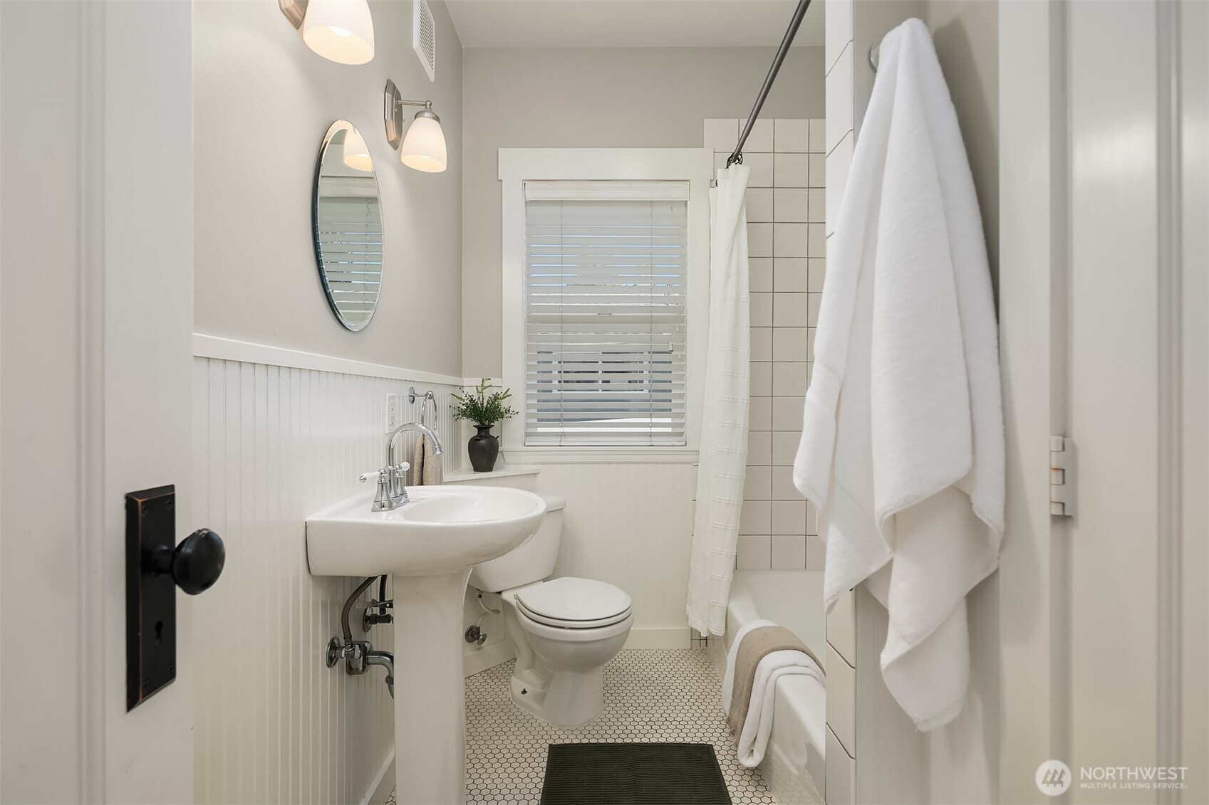 902 North 93rd Street Seattle, WA 98103 - Photo 10 of 34 a bathroom with a sink toilet and shower