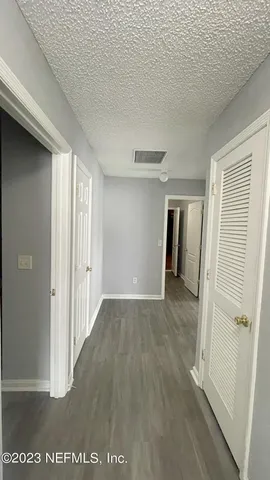 a view of hallway with wooden floor