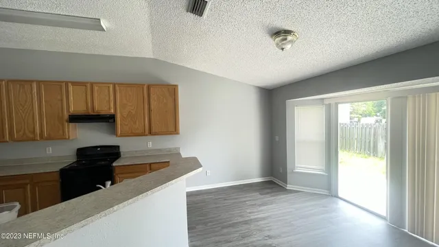 a kitchen with a refrigerator and a stove top oven