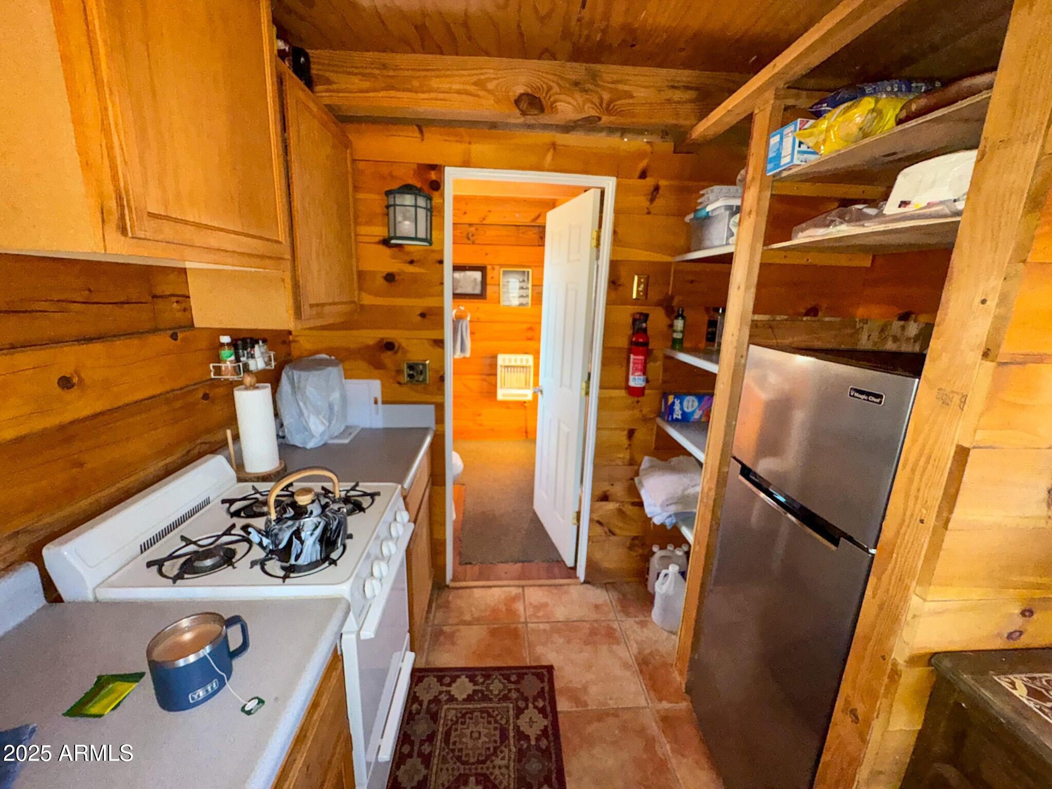 5823 Cattle Guard Road Williams, AZ 86046 - Photo 24 of 48 a kitchen with a refrigerator and a stove