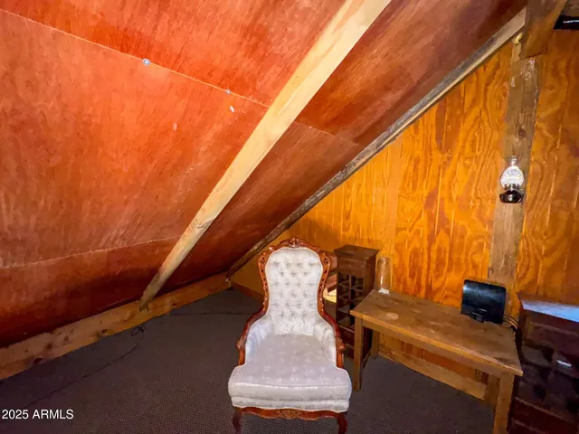 a view of a dry yard with wooden floor and fence