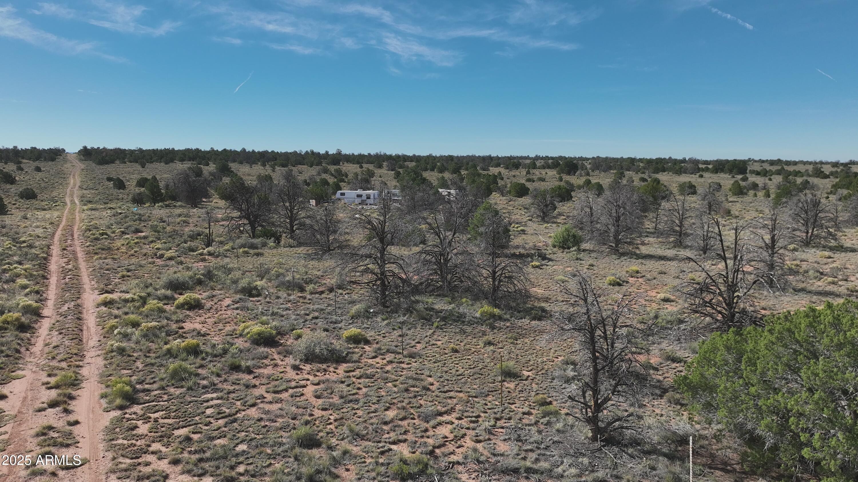 5823 Cattle Guard Road Williams, AZ 86046 - Photo 45 of 48 a view of a dry yard with wooden floor and fence