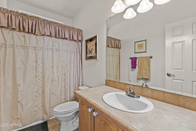 a bedroom with a bed couch and a window