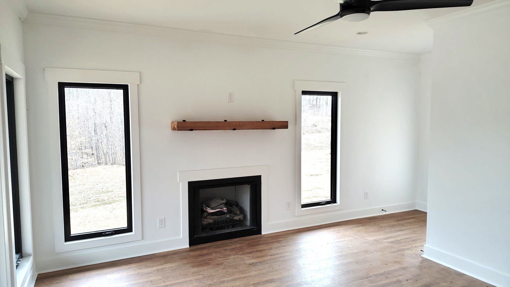 943 Overlook Trail Stewart, TN 37175 - Photo 12 of 35 an empty room with windows and a fireplace