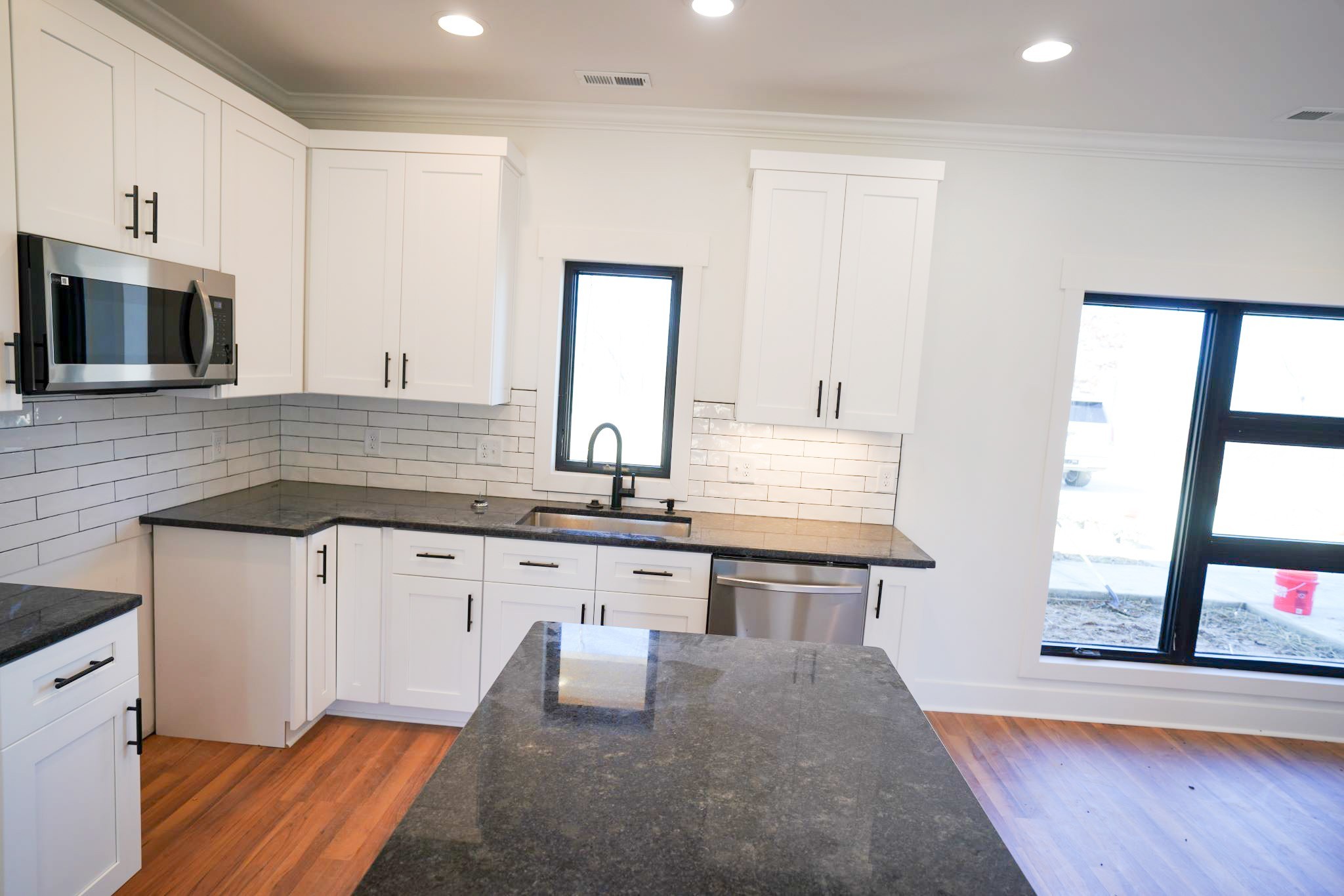 943 Overlook Trail Stewart, TN 37175 - Photo 13 of 35 a kitchen with granite countertop a stove a sink and a microwave