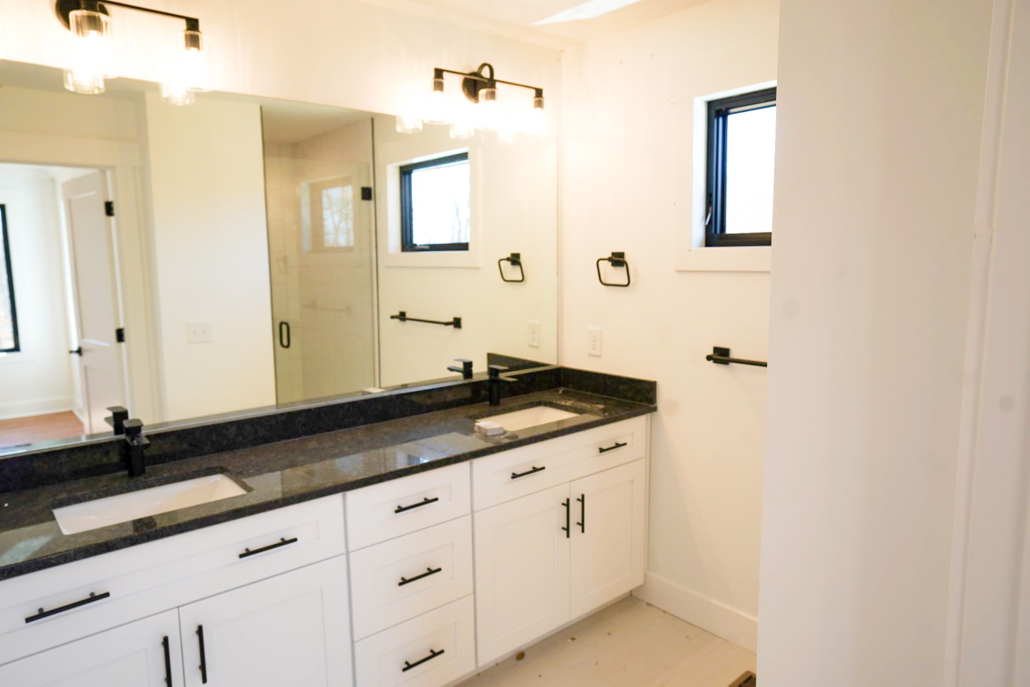 943 Overlook Trail Stewart, TN 37175 - Photo 27 of 35 a bathroom with a granite countertop sink and a mirror