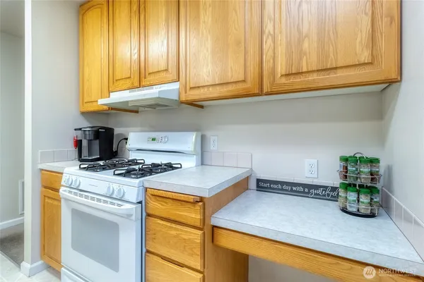 a kitchen with stainless steel appliances granite countertop cabinets and a stove top oven