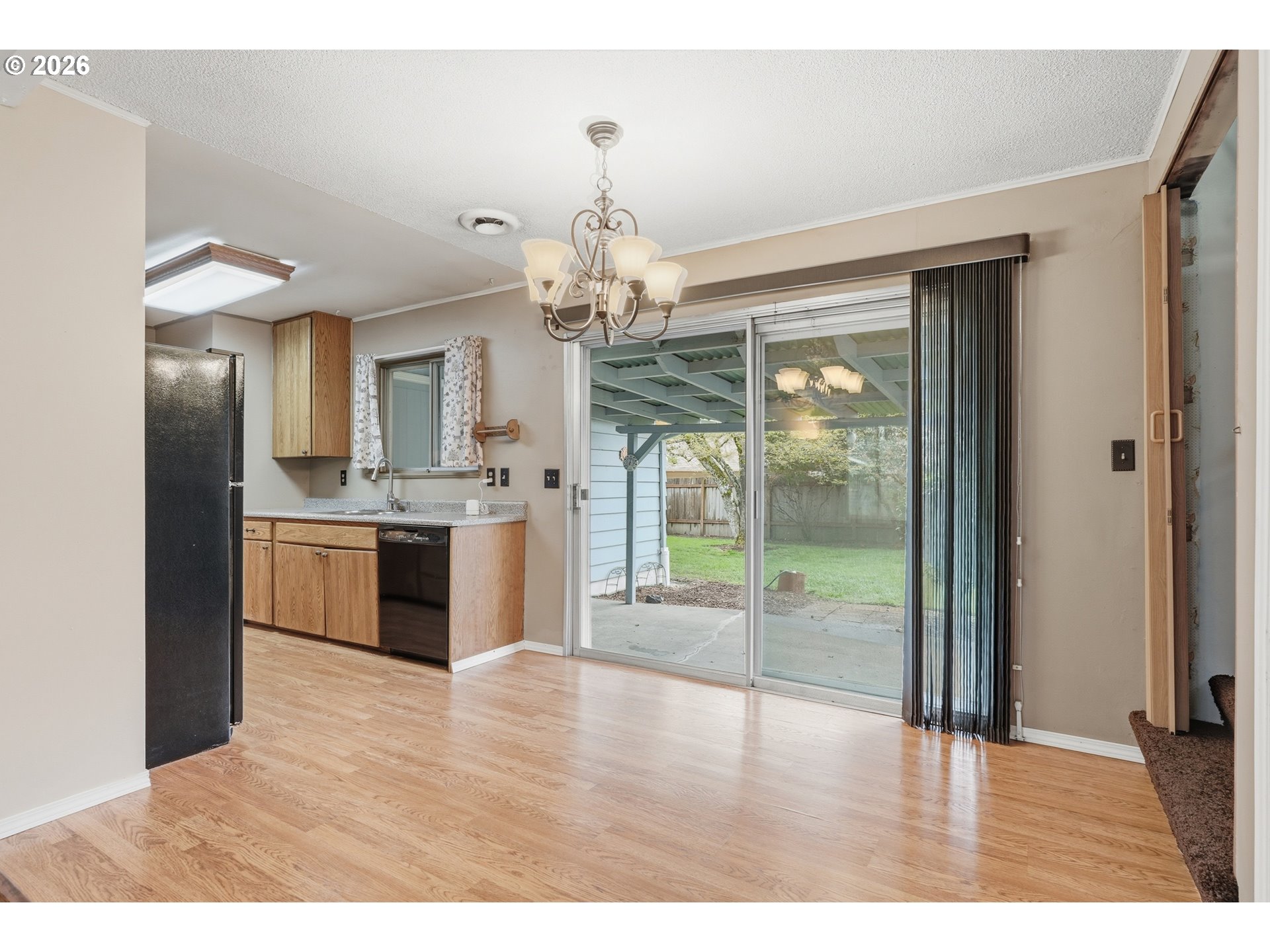335 Southwest 141st Avenue Beaverton, OR 97006 - Photo 12 of 42 a kitchen with stainless steel appliances granite countertop a stove top oven a sink with granite countertops and cabinets
