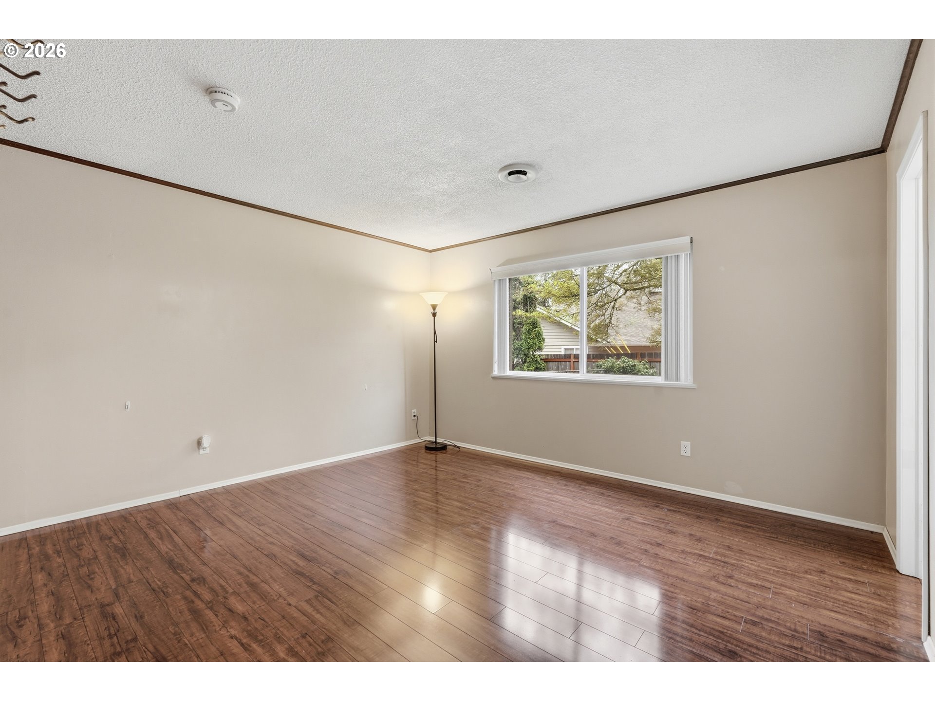 335 Southwest 141st Avenue Beaverton, OR 97006 - Photo 16 of 42 an empty room with wooden floor and windows