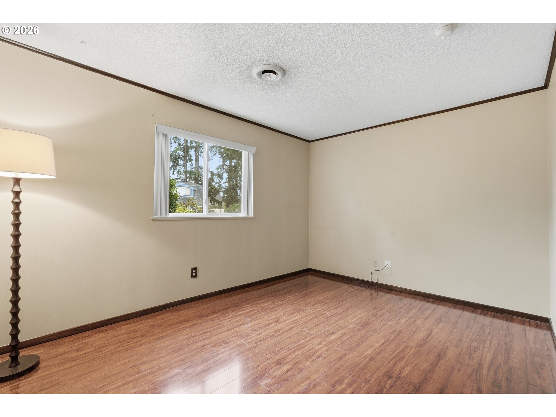 335 Southwest 141st Avenue Beaverton, OR 97006 - Photo 20 of 42 a view of an empty room with wooden floor and a window